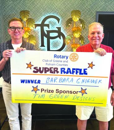 Rotary Raffle prize sponsor Tim Green (left) and Rotarian Rick Siddons presented a Tim Green Designs gift vasket valued at $300 to Rotary Raffle No. 19 prize winner Barbara Gniewek, who was unavailable for the photo. CONTRIBUTED