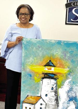 Putnam County Board of Education member Doris Clemons accepts a painting after her name was drawn during a raffle at the Putnam County Board of Education meeting. Clemons announced she would donate the artwork to the PCBOE. ALIVIA BLANTON/ Staff