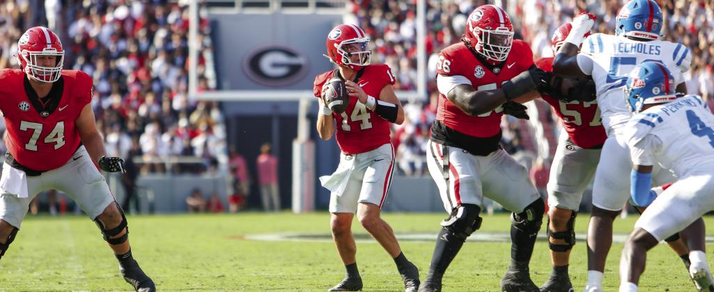 Georgia quarterback Gunner Stockton (14) drops back to pass from the pocket during a game against Ole Miss last season. LANCE McCURLEY/Staff