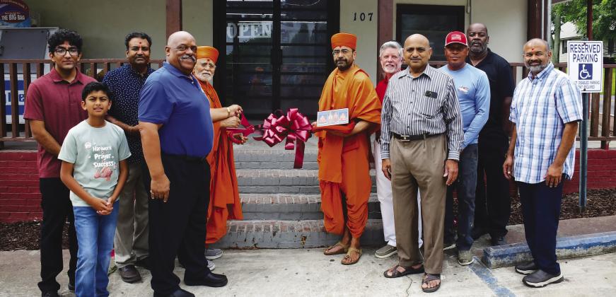 Store owner Neil Patel (third from left) was joined by Eatonton Mayor John Reid (blue shirt), two “saints” from BAPS Mandir, and Eatonton-Putnam Chamber of Commerce CEO Robbie King (red shirt), among others, for a Memorial Day ribbon cutting at Stop N Go, on Eatonton’s Martin Luther King Jr. Drive.