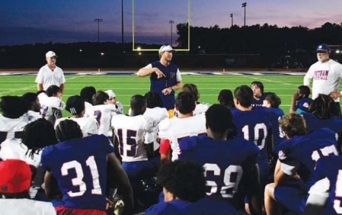 Putnam County High School head football coach Joel Harvin (center) addressed his team following the annual Spring Game to help assess talent and determine positions before the next season begins. IAN TOCHER/Staff