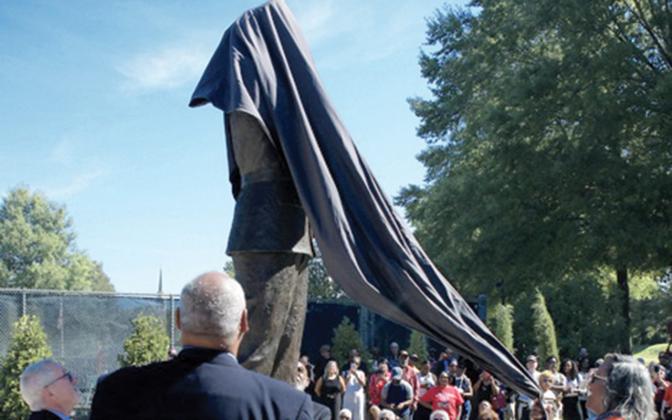 Marshall Little watches as the statue of his father, Hiram Little, is finally revealed before an appreciative crowd in downtown Eatonton.