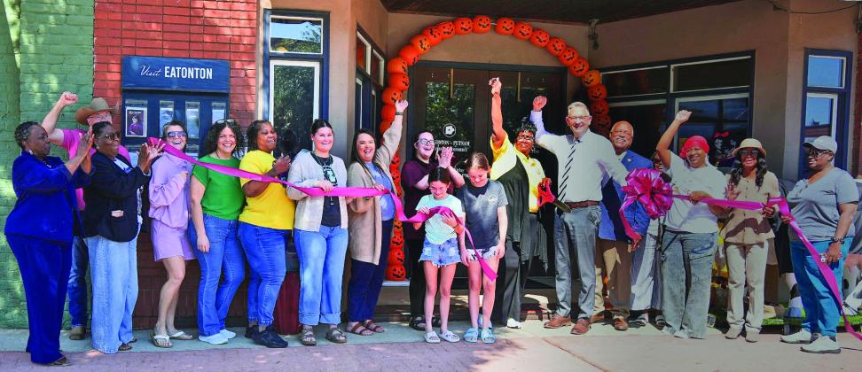 A large group of local well-wishers, including Eatonton Mayor John Reid (4th from right) and his wife Janie (far left), joined several other downtown business owners in welcoming Toys for Tots to a ribbon-cutting ceremony in front of the Eatonton-Putnam Chamber of Commerce offices on East Marion Street. CONTRIBUTED