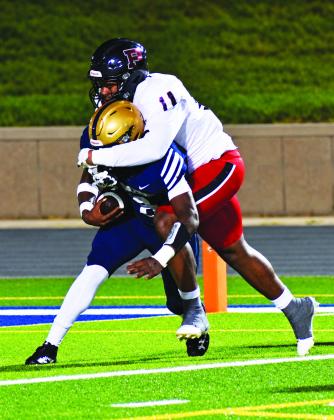 Brandon Jackson smothers a Jefferson Co. runner well behind the line of scrimmage last Friday night against the Warriors. BRANDON PARK/Staff