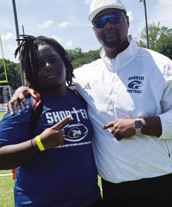Putnam County offensive lineman Jabius Farley (left) with a Shorter University coach last month. CONTRIBUTED