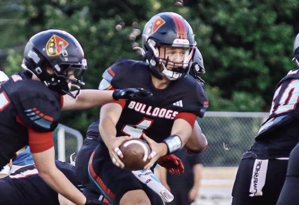 GMC Prep quarterback Cason Dennis (4) hands off the ball to a teammate last season. TREY NORRIS/Staff