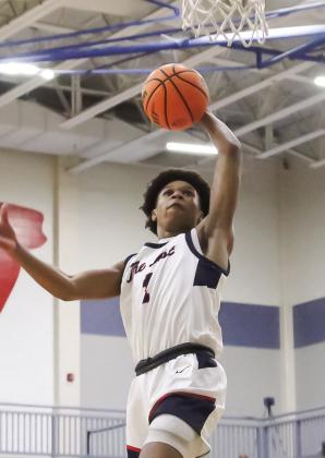 Putnam County senior guard Jeremy Banks goes up for a dunk during a game last season. Banks will take on a larger leadership role for the War Eagles this season as they look to build on last year’s run to the GHSA Class 2A Elite Eight. TREY NORRIS/Staff
