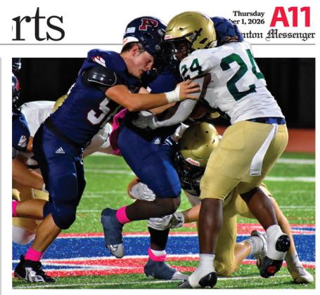 Despite losing his helmet, Gavin Aultman continues to help running back Kumari Thomas push forward for extra yards last Friday night against Aquinas. BRANDON PARK/Staff