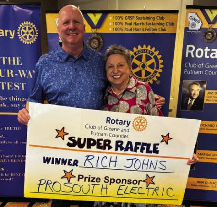 Rotary Raffle Week 38 winner Rich Johns accepted from Rotarian Micki Tanner his prize of a $300 Home Depot gift card, sponsored by ProSouth Electric. CONTRIBUTED