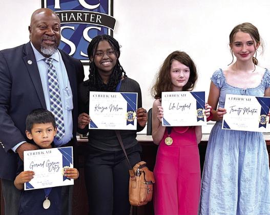 Putnam County Board of Education Superintendent Derick Austin recognized the Superintendent’s Students of the Month for May, including (l-r) Gerard Garcia Ortiz, Kenzie Nelson, Lila Langford, and Trinity Martin. ALIVIA BLANTON /Staff
