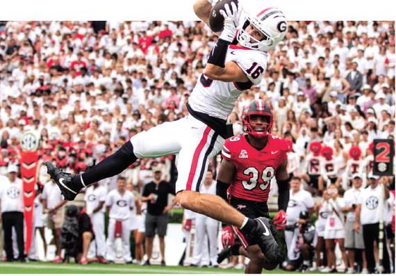London Humphreys (16) elevates to haul in a pass from Georgia quarterback Gunner Stockton. SKYLA MORRIS/Staff