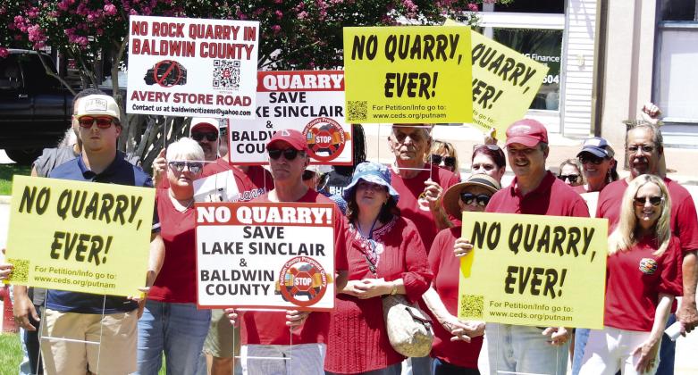 Protestors from Putnam and Baldwin counties combine Sunday afternoon on the Putnam County Courthouse lawn to commiserate and share their concerns about three potential quarry projects coming to Lake Country. IAN TOCHER/Staff