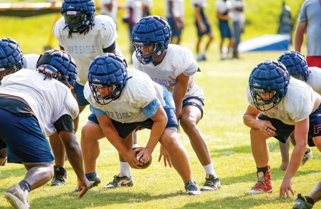 Putnam County junior quarterback Caleb Reeves lines up under center during a practice last week. LANCE McCURLEY/Staff