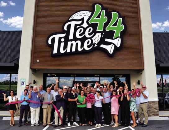 The ribbon falls to officially open Tee Time 44 last Thursday, a new electronic golf training and bar/restaurant for gourmet-seeking golf enthusiasts.