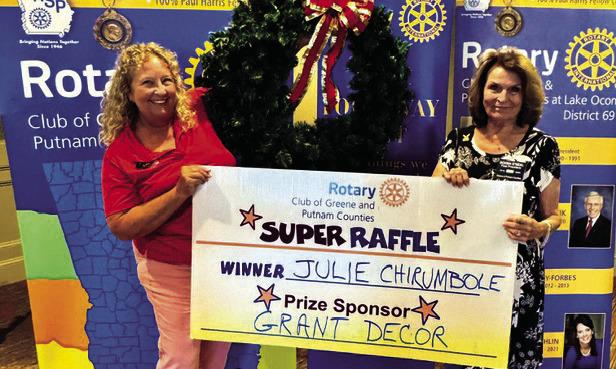 Rotary Raffle prize sponsor Leslie Grant of Grant Decor (left) poses with Rotarian Donna O’Neal in presenting a 36-inch Christmas wreath valued at $300 to Week 35 winner Julie Chirumbole, who was unavailable for the photo. CONTRIBUTED