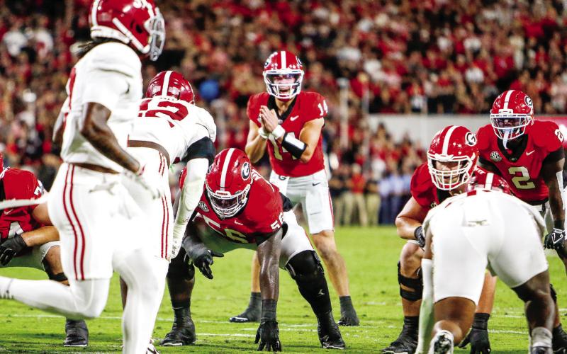 Georgia quarterback Gunner Stockton (14) in the shotgun formation, getting the offense set before a play against Alabama on Sept. 27. LANCE McCURLEY/Staff