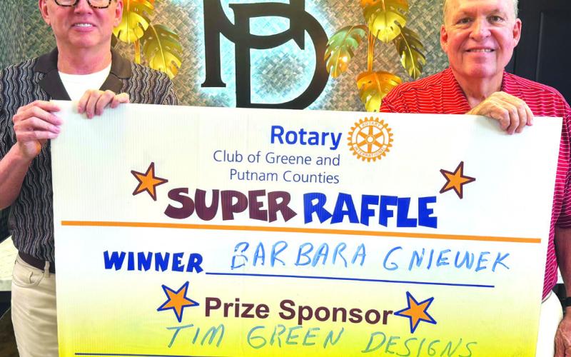 Rotary Raffle prize sponsor Tim Green (left) and Rotarian Rick Siddons presented a Tim Green Designs gift vasket valued at $300 to Rotary Raffle No. 19 prize winner Barbara Gniewek, who was unavailable for the photo. CONTRIBUTED