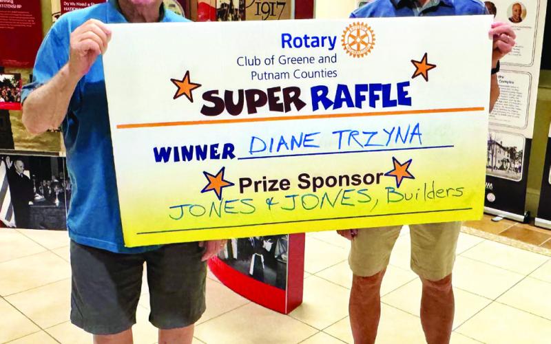 Rotarians Dom Serra (left) and Reid Conklin presented a $300 gift card, sponsored by Jones &amp;amp; Jones, Premier Builders, to Rotary Raffle No. 20 prize winner Diane Trzyna, who was unavailable for the photo. CONTRIBUTED