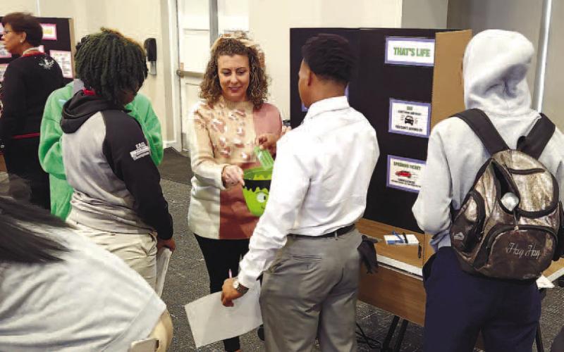 A volunteer talks students through necessities related to owning a vehicle. KARA LASSITER/Contributed