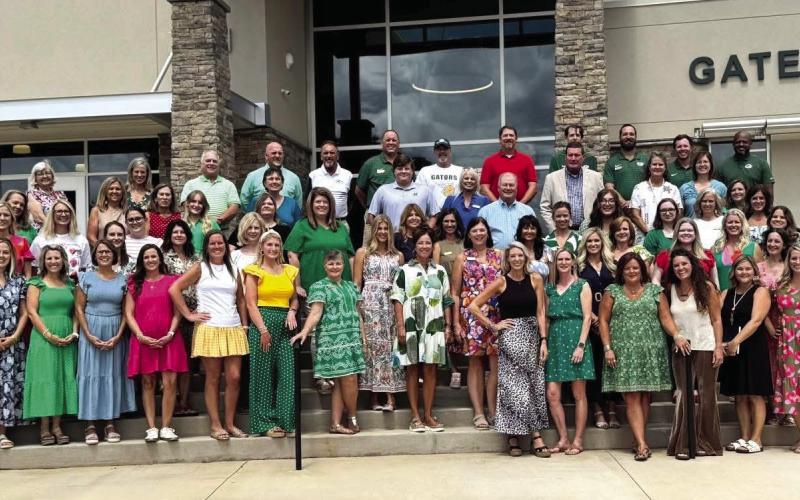 This photograph includes all the new-hires Jeff Decker (right side in beige sport coat) added at Gatewood, and who remain with the school. CONTRIBUTED