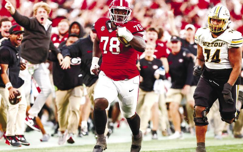 Georgia defensive lineman Nazir Stackhouse (78) returns an interception in the fourth quarter during Georgia’s game against Missouri on Dooley Field at Sanford Stadium Nov. 4 in Athens. TONY WALSH/UGA Athletics