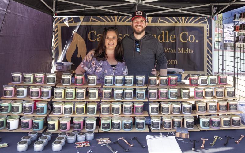 Johathan and Ashley Caruso, owners of Caruso Candle Company, were one of the many vendors Saturday. LEIGH LOFGREN/Staff