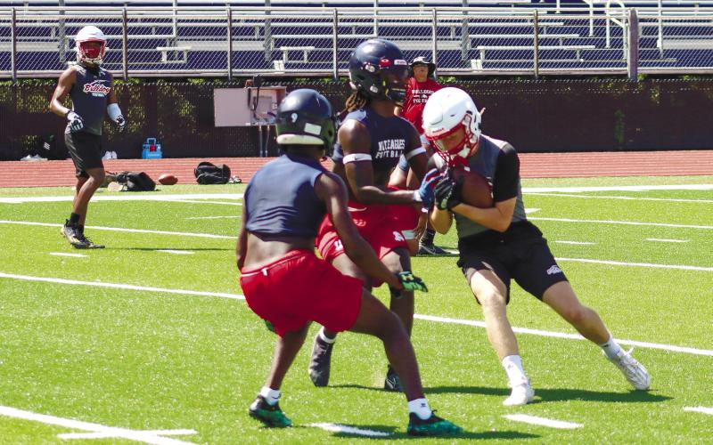 A pair of War Eagle defenders stop a GMC Prep wide receiver in covering during a recent camp. LANCE McCURLEY/Staff