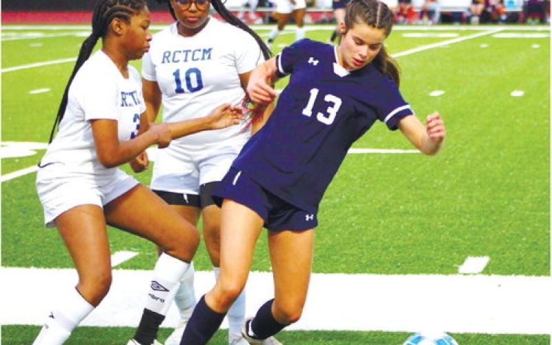 Lily Frisch (13) tries to dribble the ball a few players from RCTCM. KIM CASH/Staff
