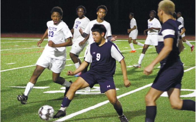 Freshman Chrisropher Perez (9) advances the ball past RCTCM defenders. KIM CASH/Staff