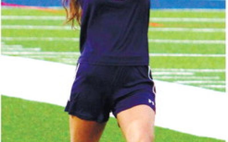 Putnam County senior Jenna McDerment (8) tosses the ball in play. KIM CASH/Staff