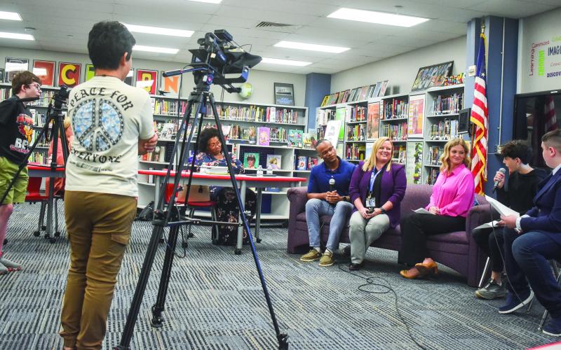 PCMS broadcasting teacher Bill Rakosnik showcased a running segment, “Q &amp;amp; A with Faculty,” on the in-school broadcast show produced by his class. The demonstration showed student anchors and camera crew at work and the segment was recorded live in front of the board. BAILEY MCCULLY/Staff