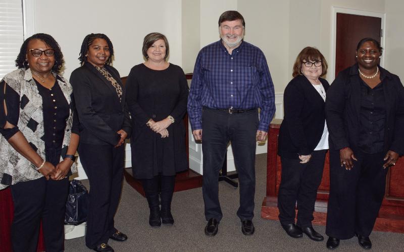 All wearing black to reflect the ink they prefer to use, members of the Putnam County Charter School System finance department (l-r) Tammy Kilgore, Nichole Crawford, Suzie Davis, Randy Pate, Judy Jones, and Coretta Harris attended Monday’s school board meeting, where they were recognized and thanked for their diligence and dedication. IAN TOCHER/Staff