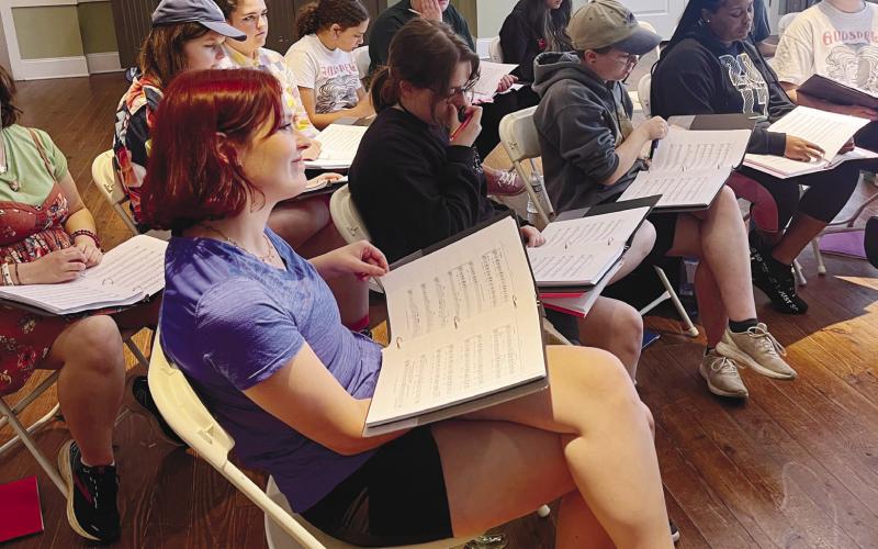 The cast of Suessical prepares for their upcoming show by practicing and reviewing their scripts as a group. CONTRIBUTED