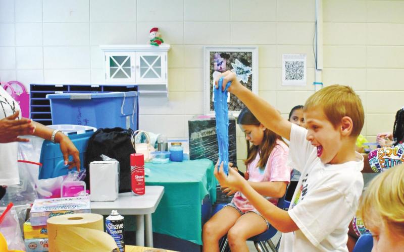 Mason Twortoer, left, and Logan Thomas are excited to play with their slime. LENA HENSLEY/Staff