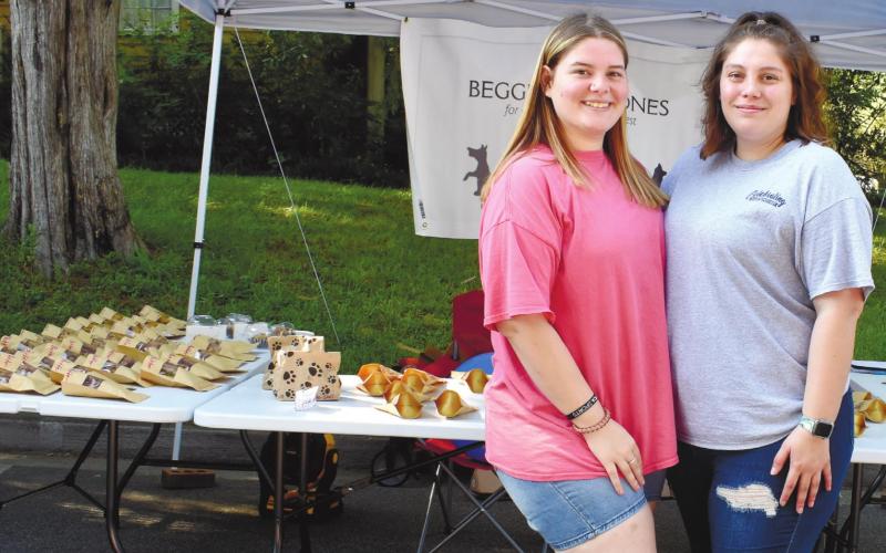 Allie Scott and her sister, Brooklyn Scott run a Beggin’ for Bones tent at the Dairy Festival. BAILEY BALLARD/Staff