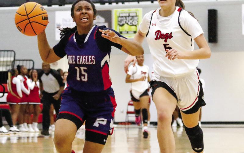 Putnam County guard Melody Richardson (15) drives past Morgan County’s Sadie Green as she tries to make an easy basket. LANCE McCURLEY/Staff