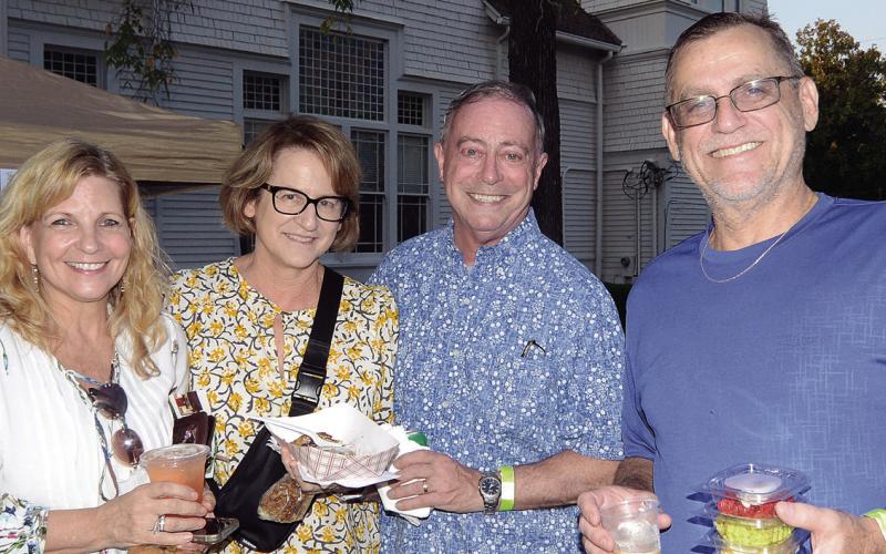 L-R: Gina Thomason, Diana Homeier, Michael Homeier, and John Thomason each found different treats at the Taste of Eatonton last Monday night. LEIGH LOFGREN/Staff