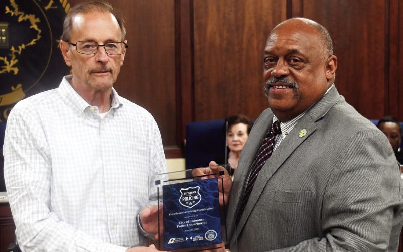 Eatonton Police Chief Howell Cardwell, left, accepts the award by Georgia Municipal Association from Eatonton Mayor John Reid. IAN TOCHER/Staff