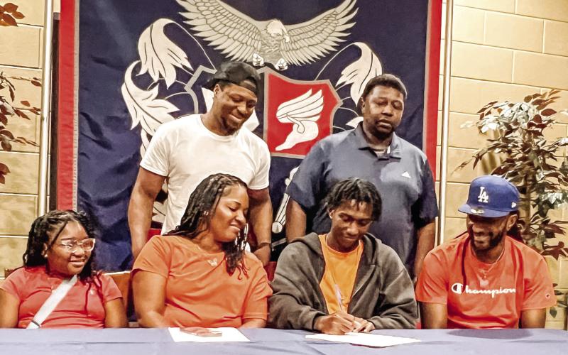 Jaylin Harper signs a letter of intent to attend and play for Brewton-Parker College during an event held for him at Putnam County High School on May 22. CONTRIBUTED