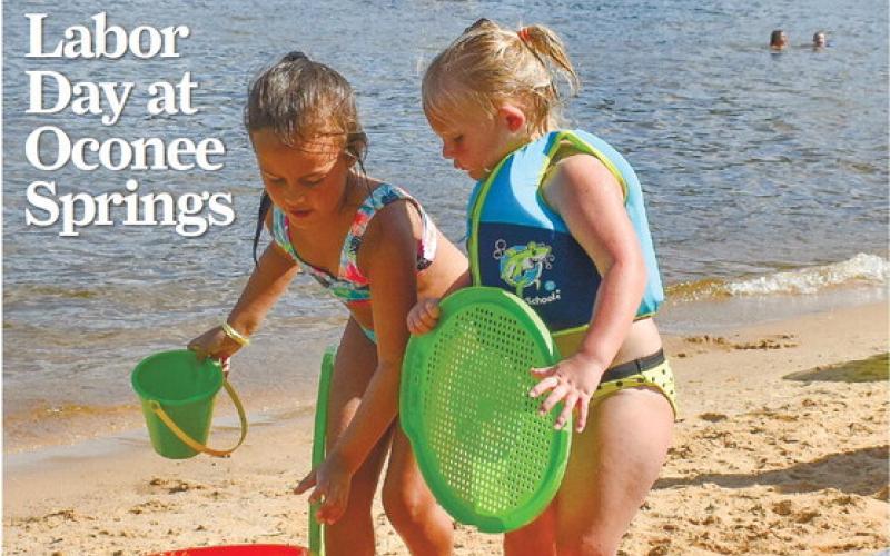 Paisley G. and Harper F. gather all their materials to build a sandcastle during Labor Day festivities at Putnam County’s Oconee Springs Park. SEE MORE PHOTOS &amp;gt;&amp;gt; PAGE B1 LENA HENSLEY/Staff