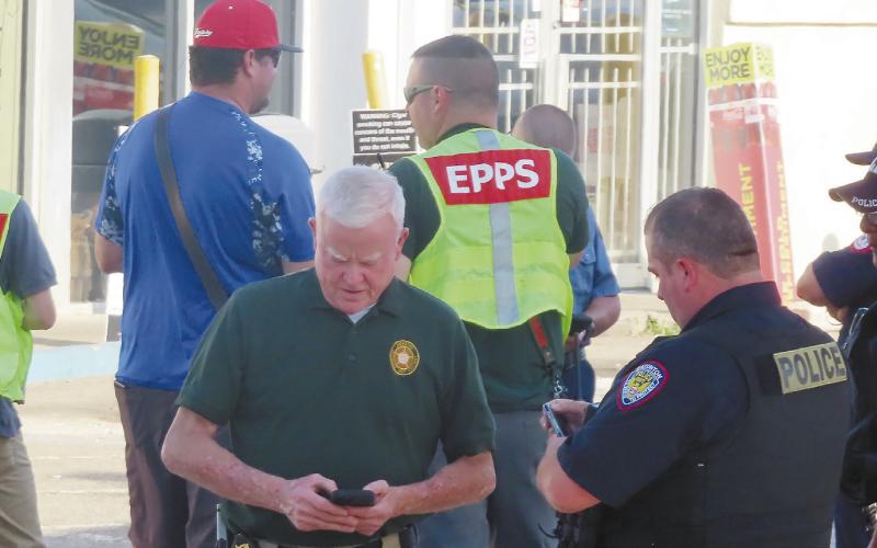 Eatonton police officers, fire department personnel and Putnam County Sheriff’s deputies at the Shell Food Mart on Sumter Street where a shooting happened Sunday. CONTRIBUTED