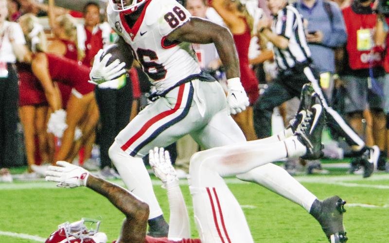 Georgia wide receiver Dillon Bell (86) runs over Alabama defensive back Keon Sabb (3) on his way to the end zone, giving the Bulldogs a 34-33 lead. LANCE McCURLEY/Staff