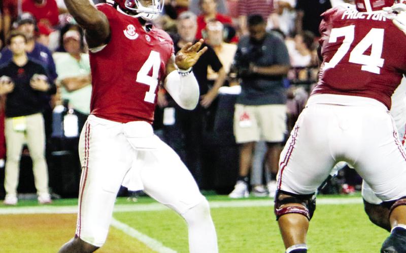 Alabama quarterback Jalen Milroe (4) gets set to fire a pass to receiver Jamarion Miller deep in Crimson Tide territory. LANCE McCURLEY/Staff