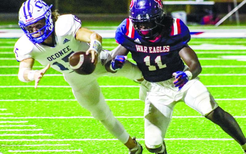 War Eagles’ outside linebacker Tyson Waller (11) chases Oconee County quarterback Max Ricks (15) out of bounds. LANCE McCURLEY/Staff