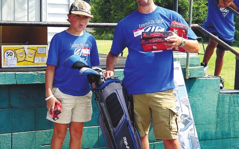 Bo Wooten wins the drawing for the golf clubs presented by Nick Schroeder with the Eatonton Elks Lodge 2549. CONTRIBUTED