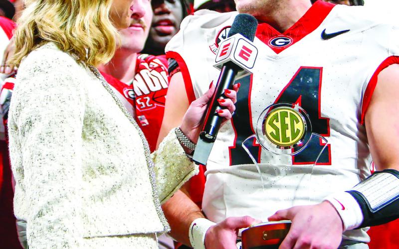 ESPN reporter Laura Rutledge (left) interviews Georgia quarterback Gunner Stockton (right) following the SEC Championship game. LANCE McCURLEY/Staff