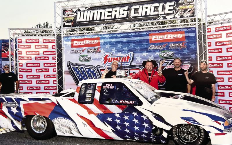 Eatonton-based racer C.G. Knight (center with hat) celebrates his No Mercy 15 win at South Georgia Motorsports Park with crewmembers Doug Colbert (left), Jason Mote, and Richard Disher. CHRIS SIMMONS/Contributed