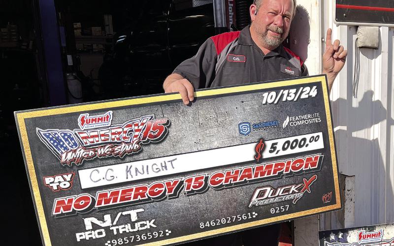 Outside his G’s Automotive shop in Eatonton, C.G. Knight enjoys his moment in the sun. CONTRIBUTED
