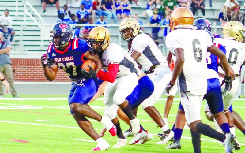 Putnam County running back Tamarion Peters (27) tries to find a hole through Oconee County’s defense. Peters also had a big impact against Jasper County. ARELLA CASH/Staff