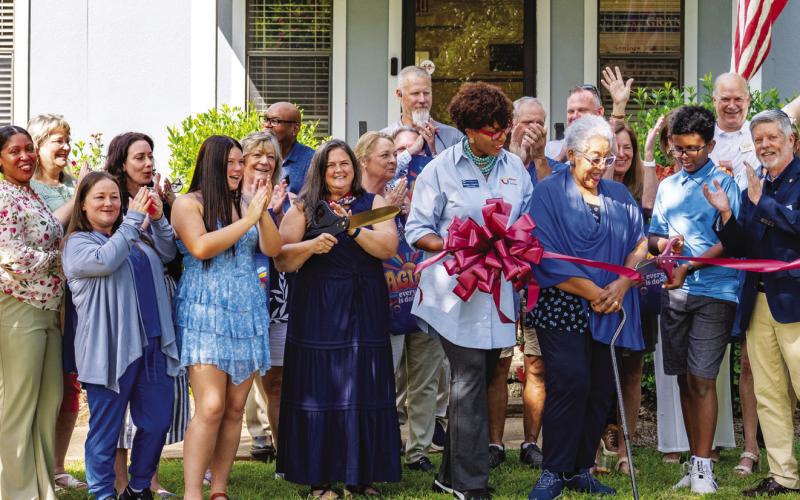 Employees and supporters of Seniors Helping Seniors Mid-South Georgia cheer as the ribbon is cut late last Tuesday to officially recognize the opening of the unique, new facility in Putnam County. CONTRIBUTED